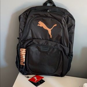 Black/rose gold puma backpack.